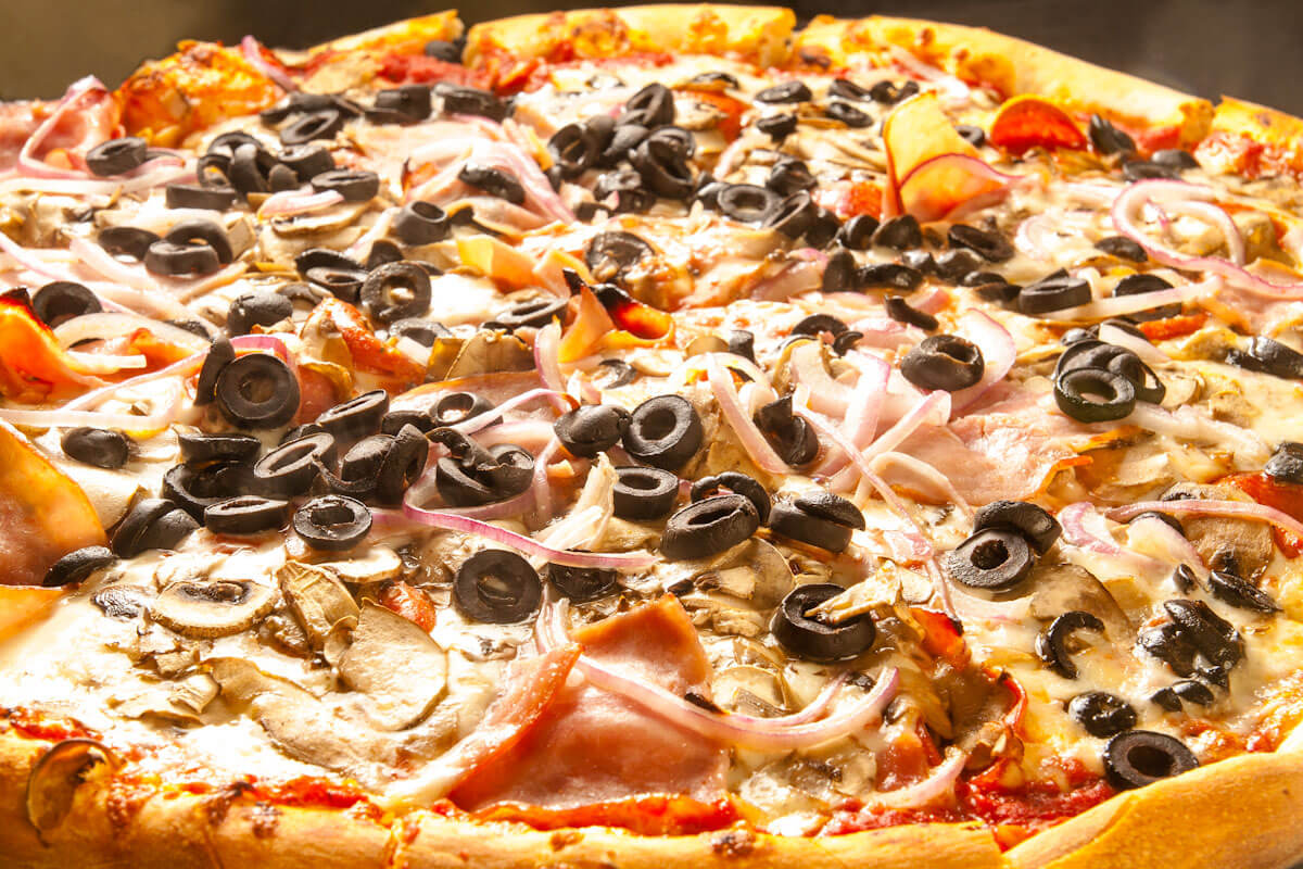 The Usual pizza with pepperoni, mushrooms, ham, red onions and olives